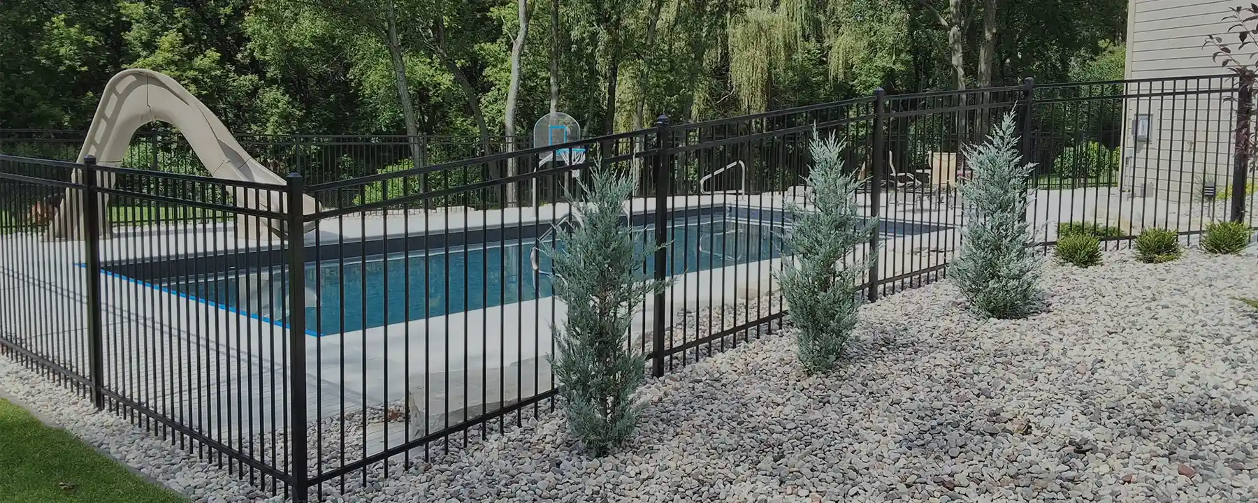 3 rail black aluminum fence surrounding a pool