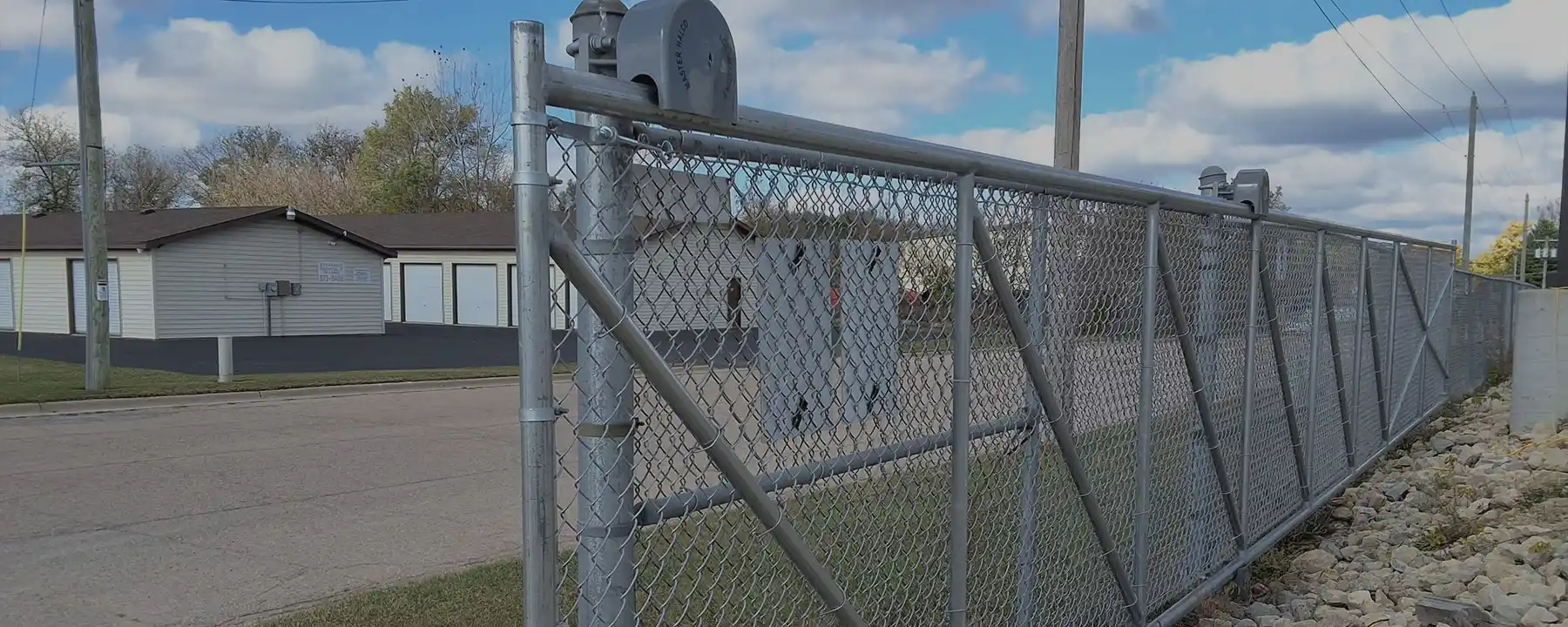 Commercial chain link fence with cantilever gate